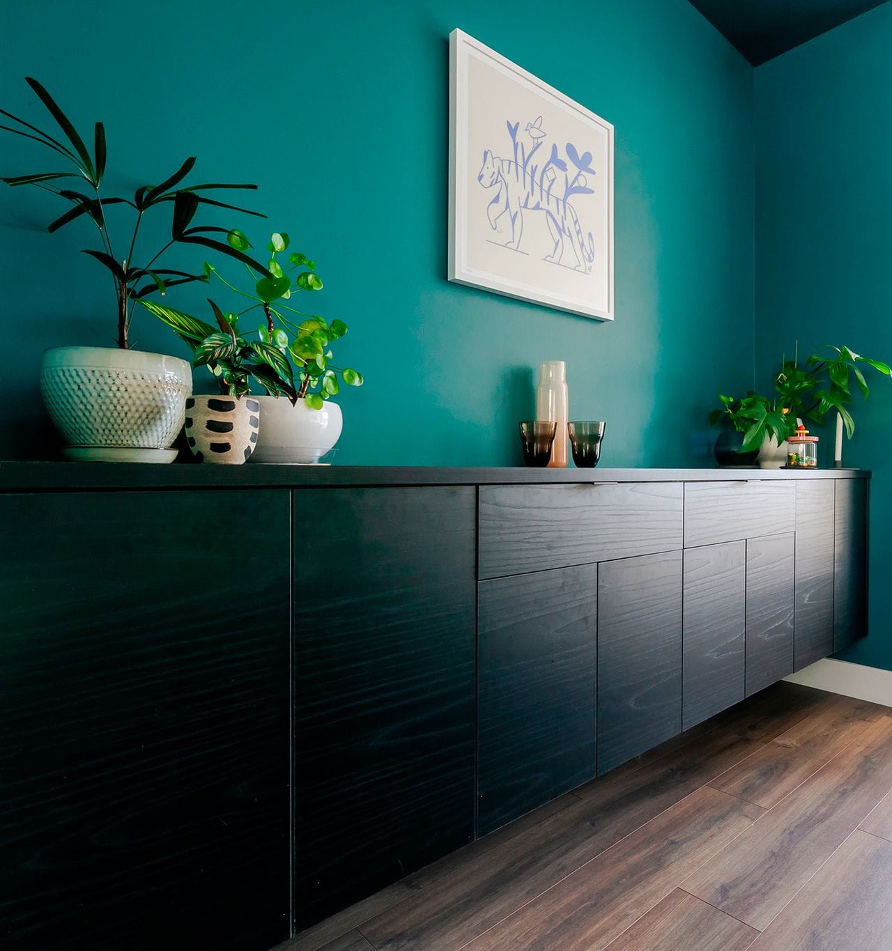 Floating credenza cabinets in dark wood finish by California Closets