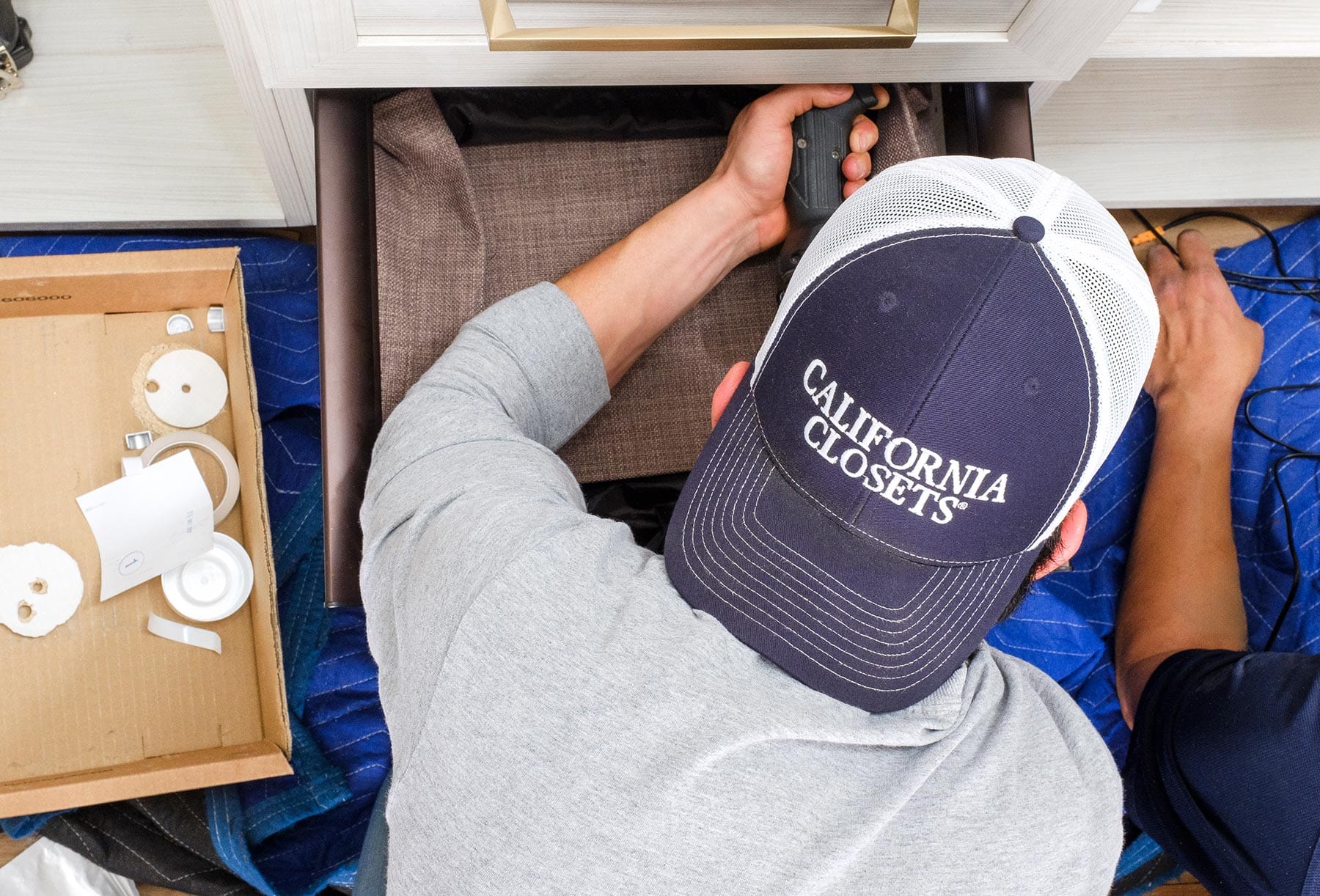 Customized cabinet being installed from Installation Technician at California Closets