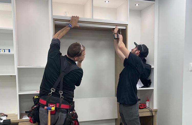 Custom cabinets built in to wall by California Closets installers