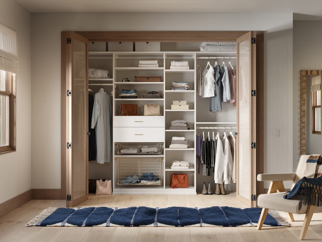 Shelving in reach in layout with dresser drawer storage and baskets by California Closets