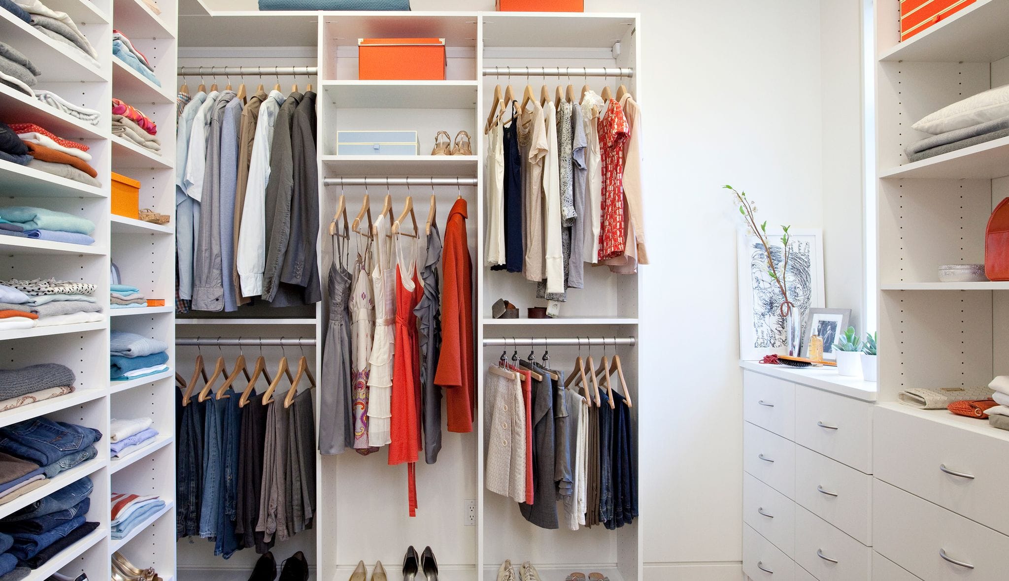 Custom wardrobe storage built with cabinets and shelves by California Closets