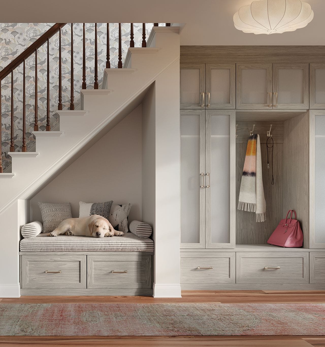 Hallway entry with custom designed cabinets, drawers, and a built in bench in a light wood finish by California Closets